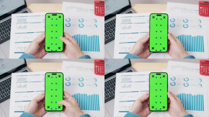 商人在办公室用绿屏色度键智能手机