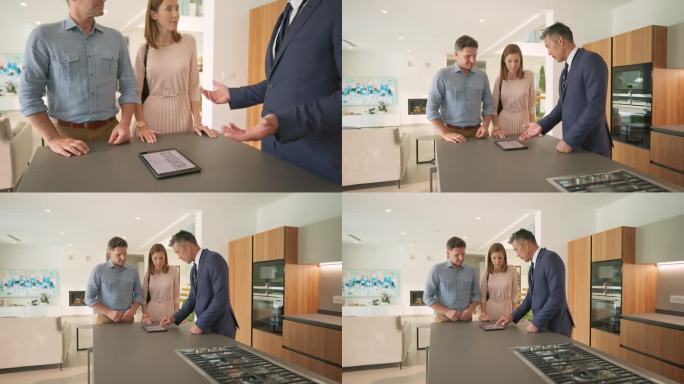 一名男性房地产经纪人向一对正在参观豪宅的已婚夫妇展示用平板电脑制作的小册子