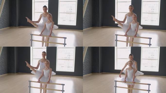 芭蕾舞演员在舞蹈工作室训练中伸展女孩的腿