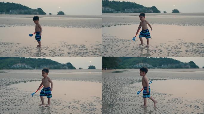 快乐的亚洲小男孩享受外出的一天，独自沿着海滩散步。环境。探索。学习。大自然。