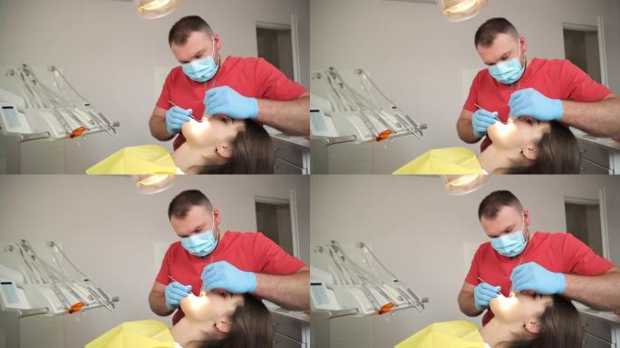 牙医用口腔镜和牙科挖掘机检查病人的牙齿。