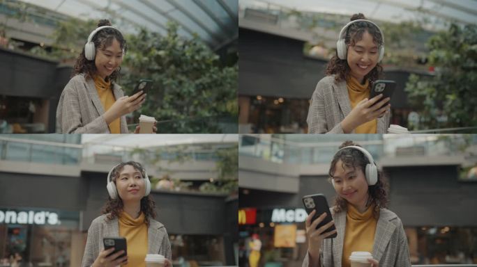 亚洲妇女在市区使用手机。