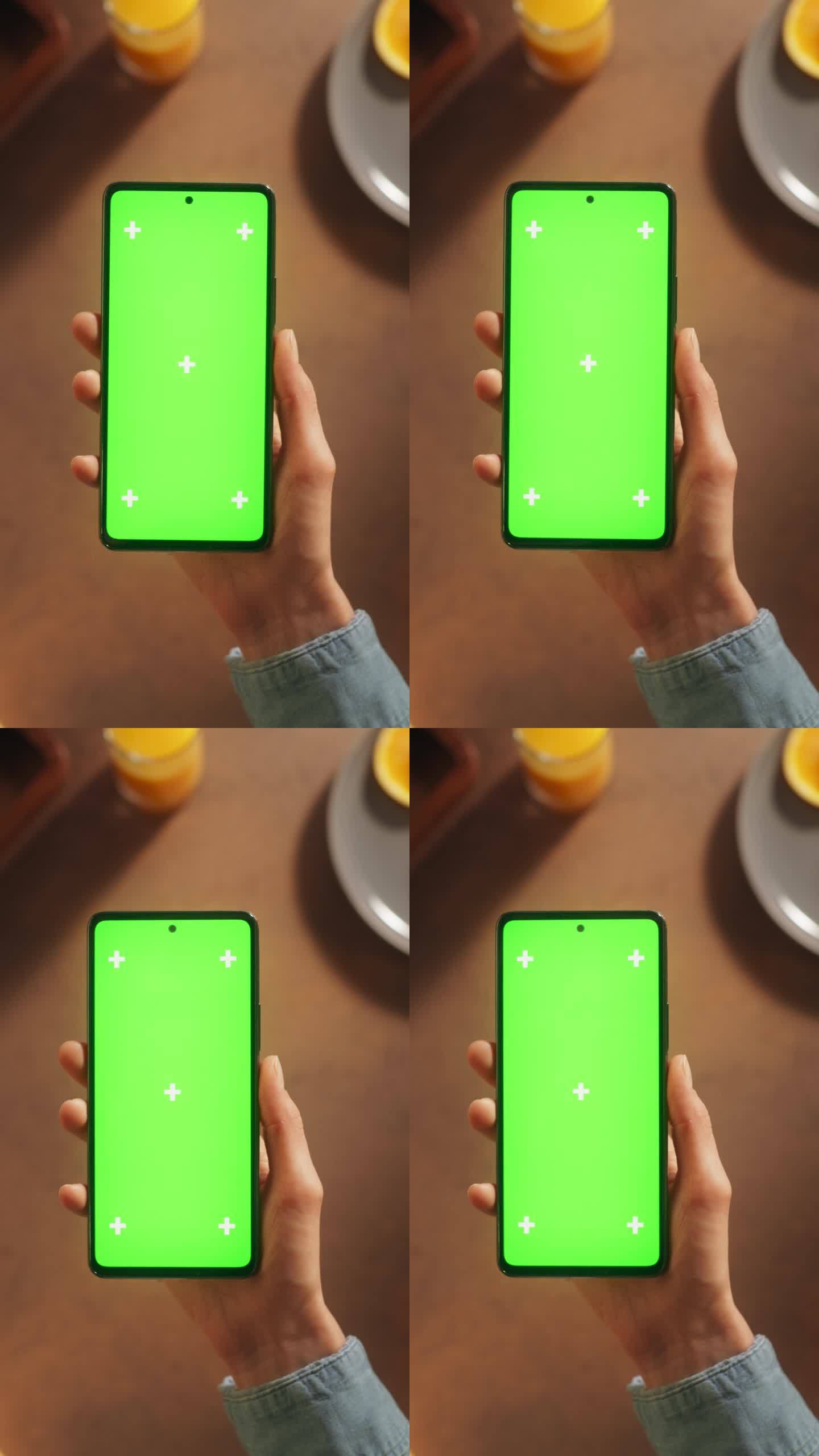 垂直屏幕:顶部静态视图匿名妇女使用智能手机与模拟绿色屏幕Chromakey显示在厨房餐桌上的食物配料