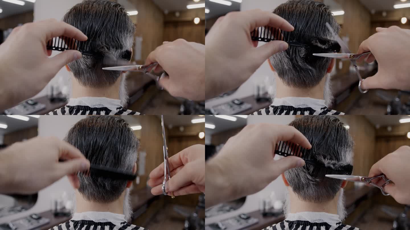 成熟男子在理发店创意理发的特写，理发师用剪刀和梳子