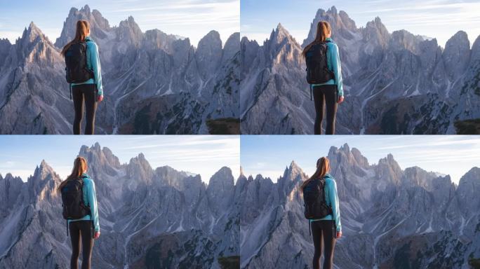 女徒步旅行者在悬崖边欣赏壮丽的景色