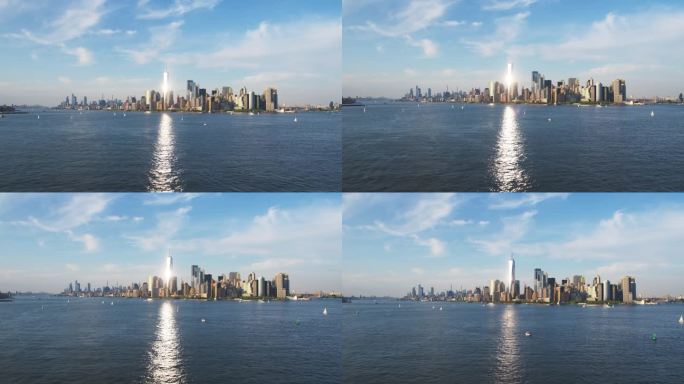 航拍镜头的摄像机接近曼哈顿岛的办公室和公寓大楼。哈德逊河风景与游艇，船只和太阳反射从一个世界贸易中心