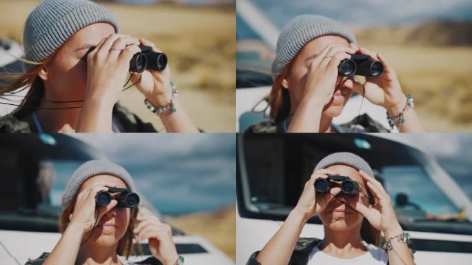 一名年轻女子用双筒望远镜观察摩洛哥的沙漠