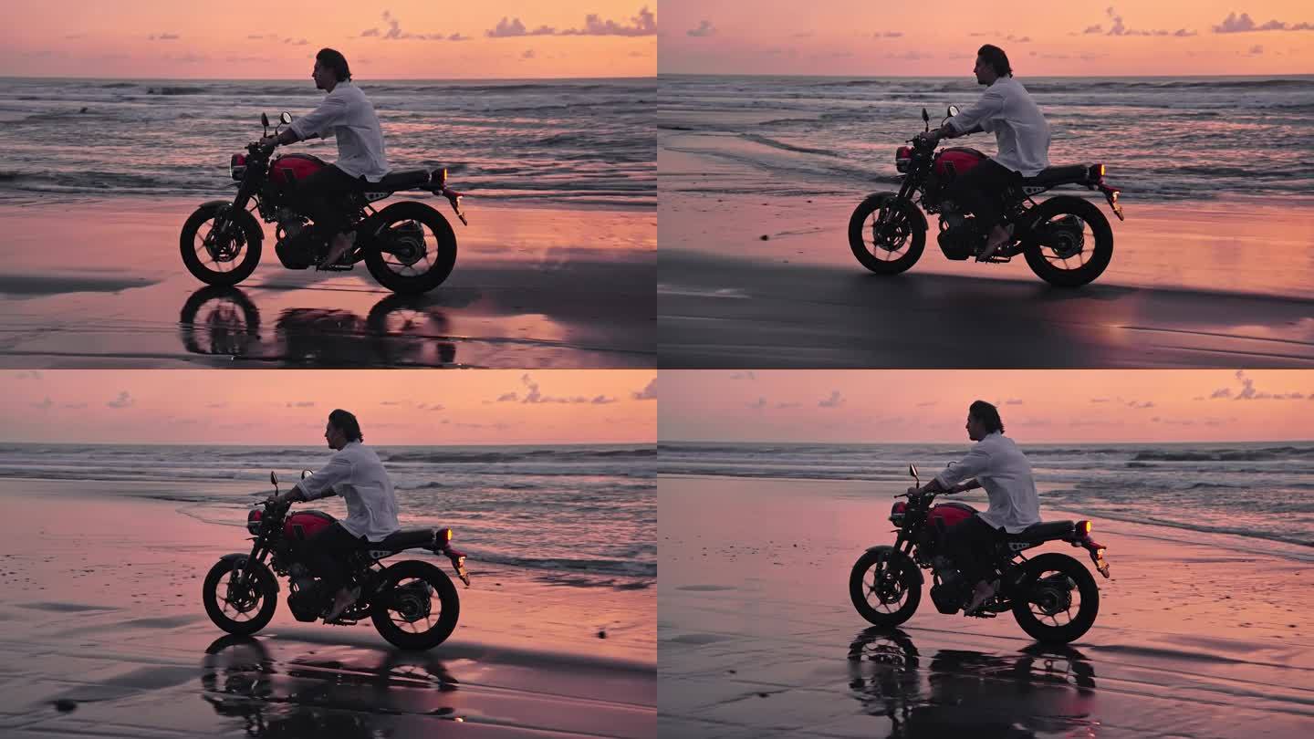 骑摩托车或在美丽的大自然的海滩户外旅行。英俊的赛车手男子在摩托车与动力摩托车骑沙子在快速行动。成人摩