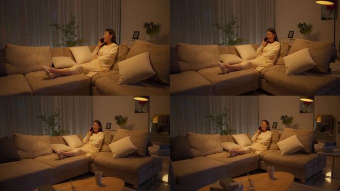 晚上，在她舒适的公寓里，一个美丽的韩国女人躺在沙发上放松，正在进行有趣的电话交谈，分享爱情和友谊的快