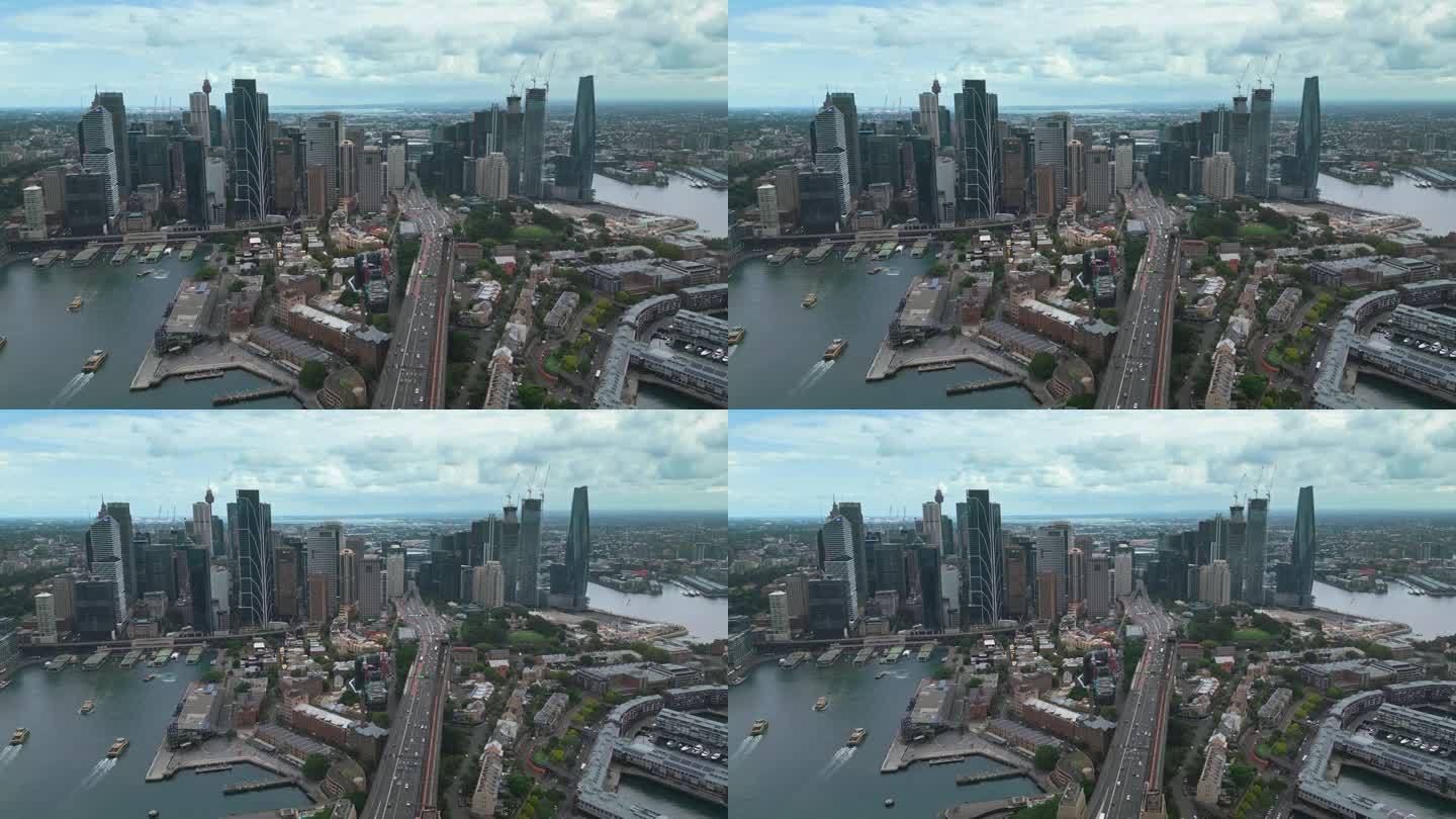 日出时悉尼中央商务区上空的4K鸟瞰图，有各种现代办公大楼和歌剧院。
