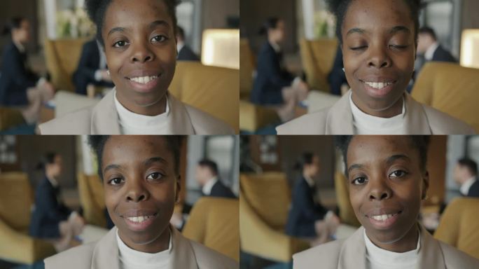 现代酒店内快乐的非裔美国商务女士的特写肖像