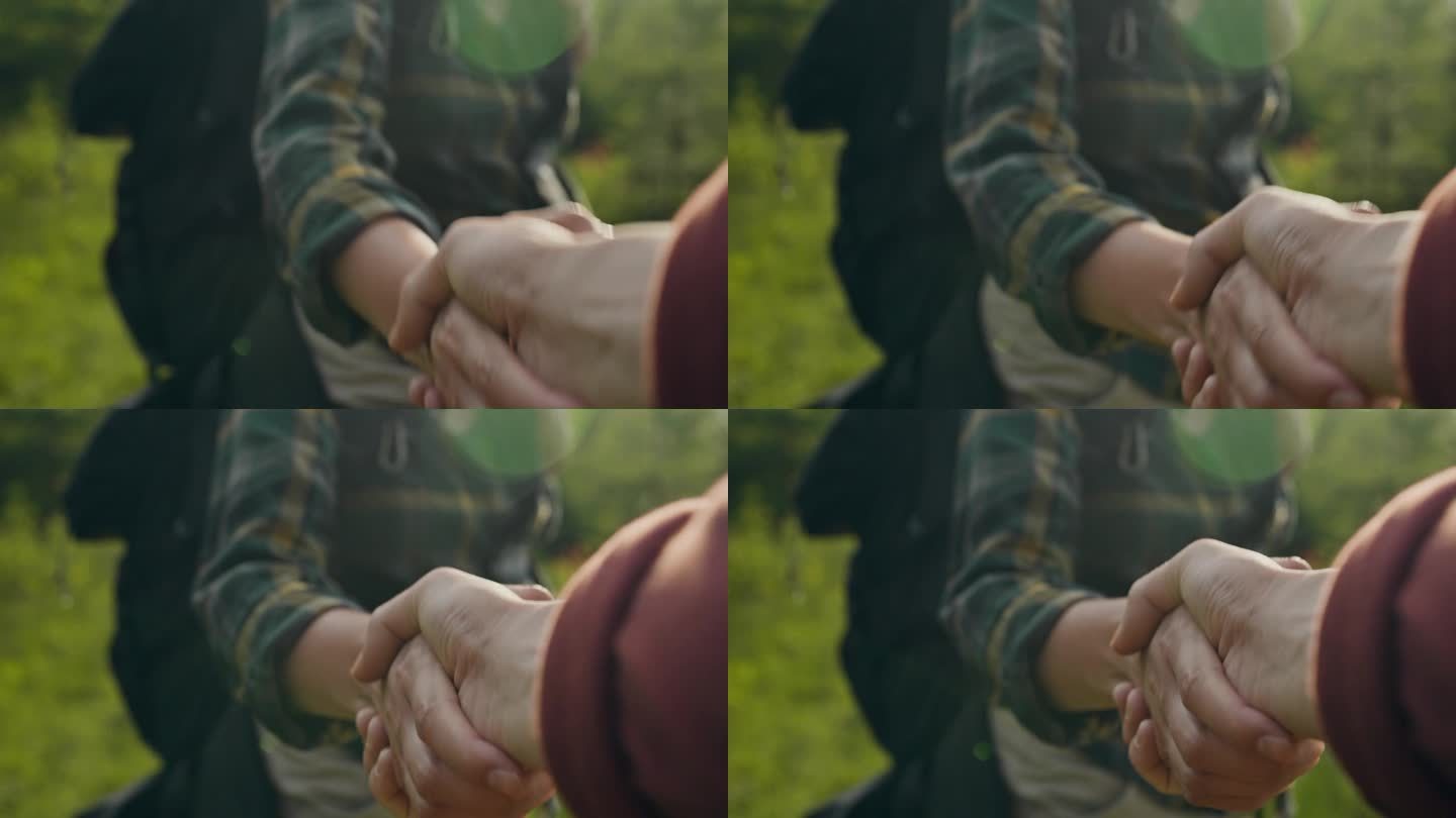 旅行中，一个年轻的女孩和一个男人握手打招呼，在野外握手。稳定的摄像机