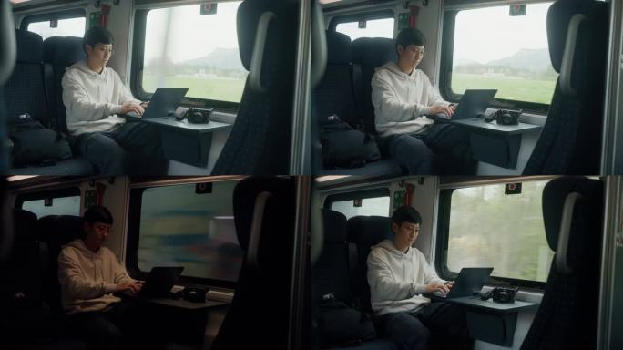 一个亚洲商人坐在火车上，一开始就望着窗外沉思。
