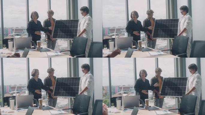 在办公室的会议室里，一位亚洲女性和她的同事正在她的同事面前做关于太阳能电池板的报告。