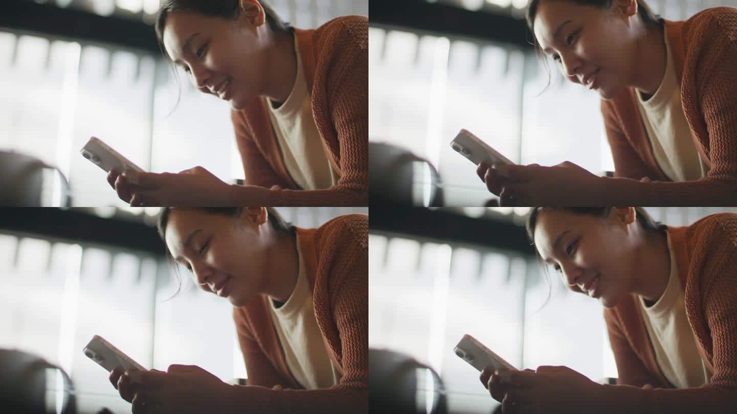 一个亚洲女人在看她的智能手机