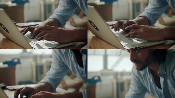 办公室里，穿着衬衫的年轻白人男子靠在胳膊肘上在笔记本电脑上打字的特写