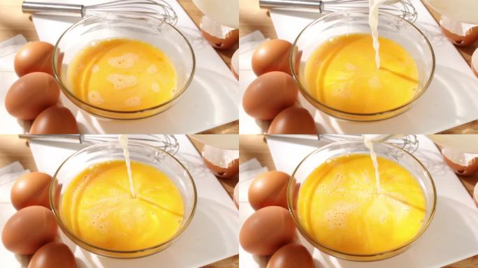 往鸡蛋里加牛奶。牛奶和打好的鸡蛋一起倒进碗里。长诚。