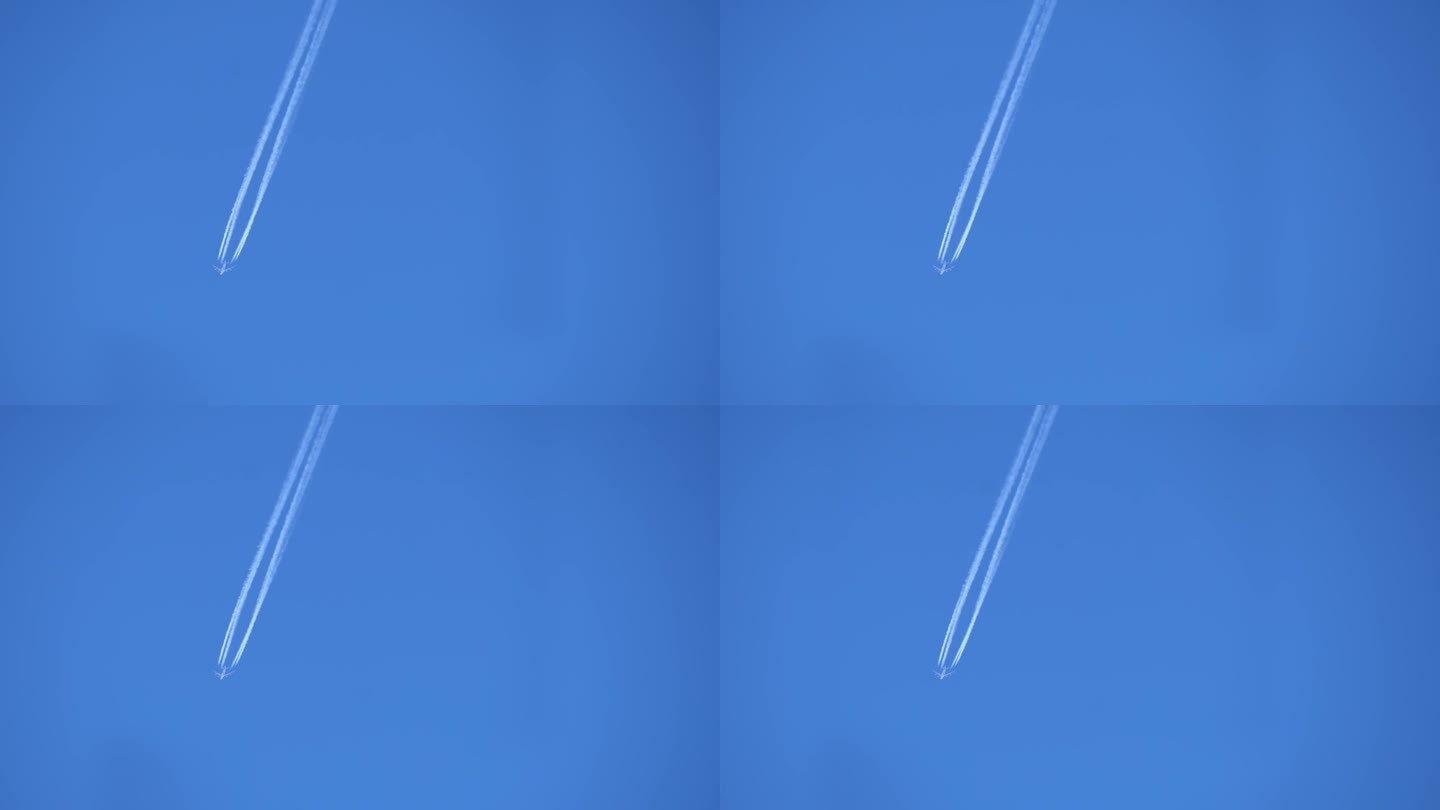 一架商用客机在晴朗的蓝天中飞行的尾迹