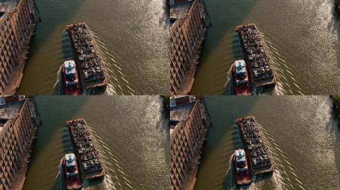 布鲁克林绿点，拖船沿着纽敦溪河拖着装满废金属的大驳船，特写。航拍视频。