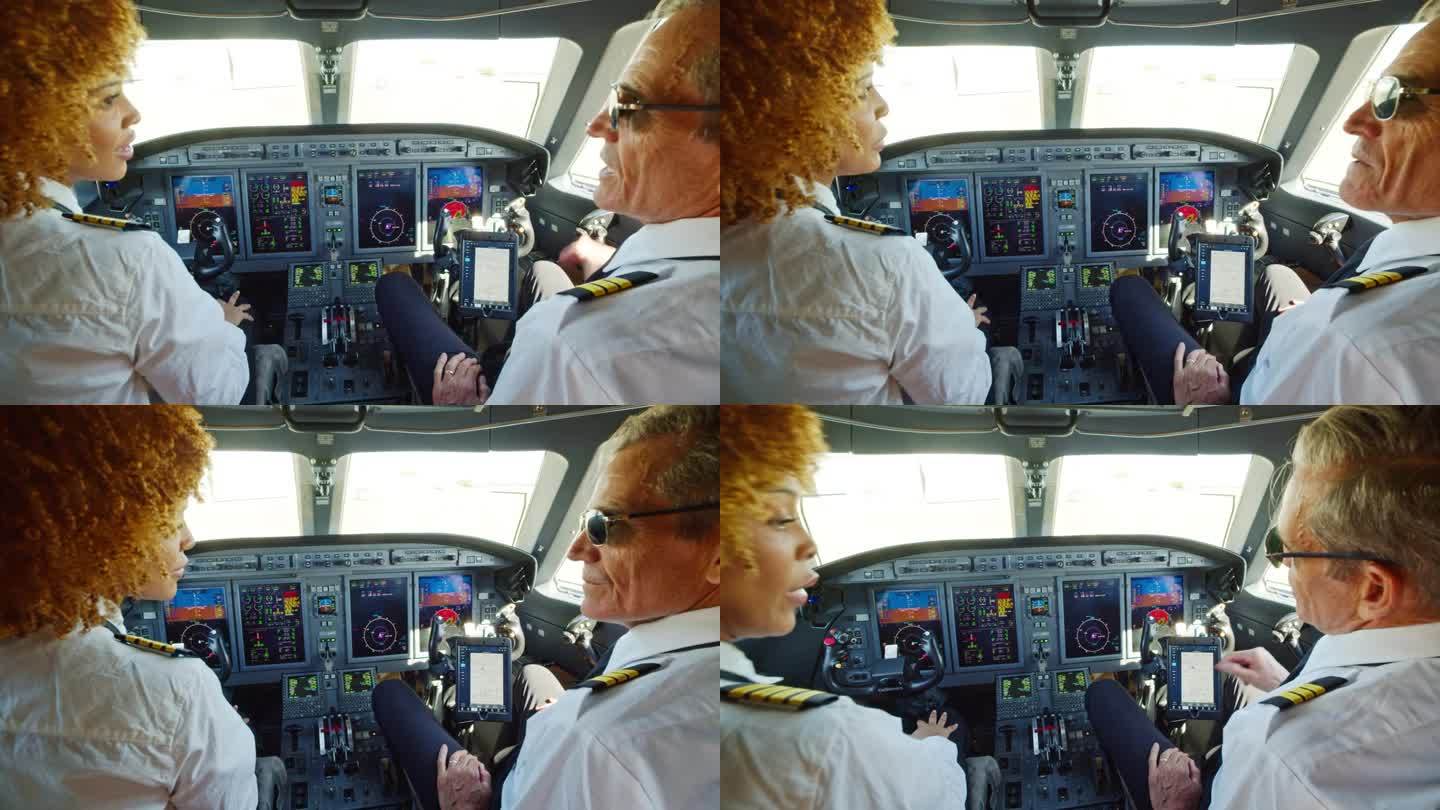 戴着墨镜的成熟白人飞行员在飞机驾驶舱内与他的非裔美国副驾驶交谈