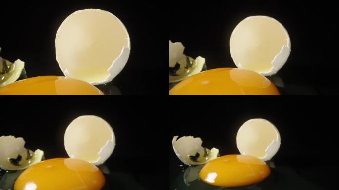 一个破鸡蛋放在黑色镜面桌子和黑色背景上。多莉滑块极端特写。
