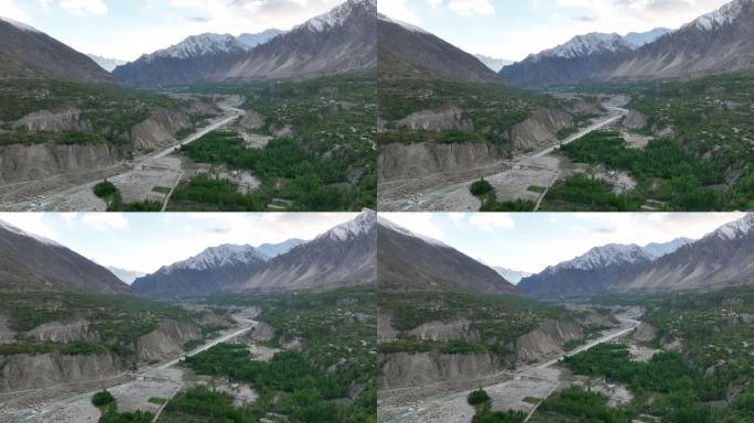 空中无人机日落景观罕萨河谷与河流和喀喇昆仑山脉山脉，罕萨河谷，吉尔吉特-巴尔蒂斯坦，巴基斯坦北部。