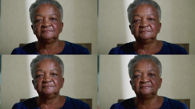 一位巴西黑人老年女性的肖像，表情中性地看着镜头。白发苍苍的老妇人特写脸