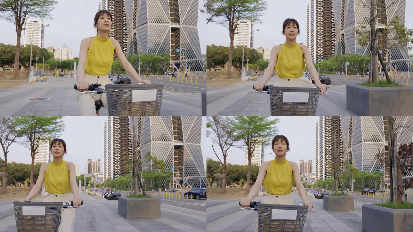 一位亚洲妇女骑着自行车穿梭在城市中。