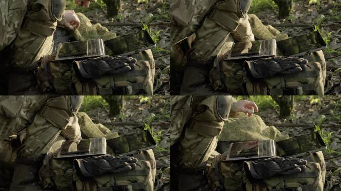 计算机技术在现代军队中的应用。士兵用手触摸着平板电脑屏幕。