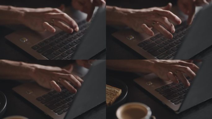 现代笔记本电脑键盘上的男性手，特写视图，在咖啡馆工作，咖啡杯和蛋糕