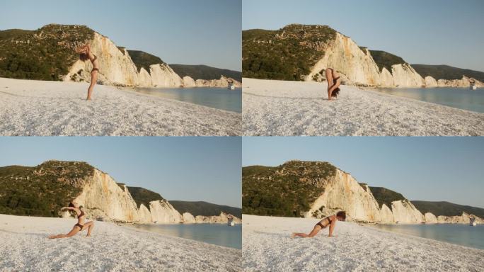 美丽成熟的女人在沙滩上向太阳瑜伽致敬。这个片段是系列的三分之一