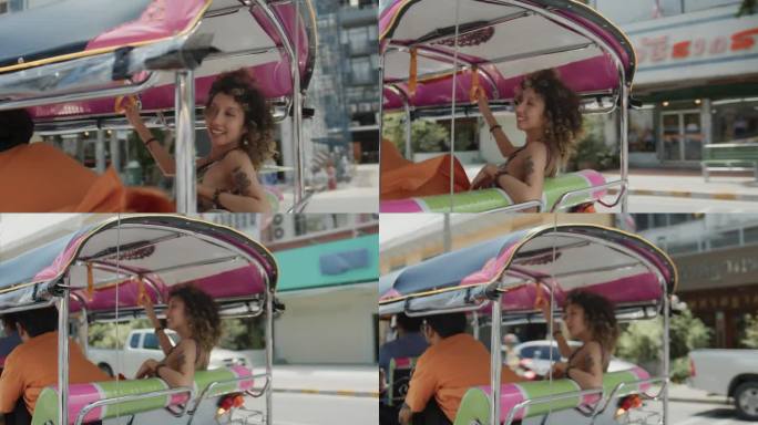 度假时在泰国旅游的年轻夫妇微笑着乘坐嘟嘟车观光交通。