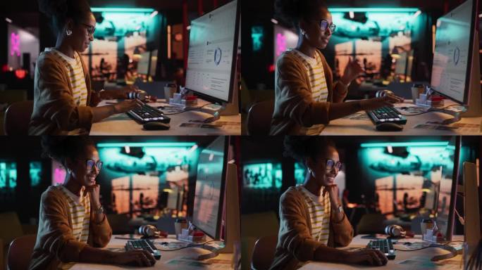 女性天才数字营销专家晚上在办公室用电脑工作。年轻的黑人女商人在创意机构，微笑和研究商业分析数据