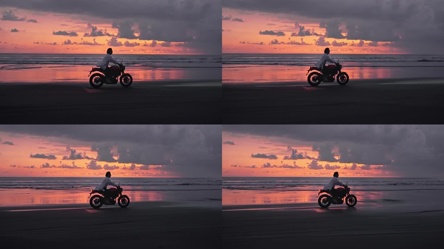 骑摩托车或在美丽的大自然的海滩户外旅行。英俊的赛车手男子在摩托车与动力摩托车骑沙子在快速行动。成人摩