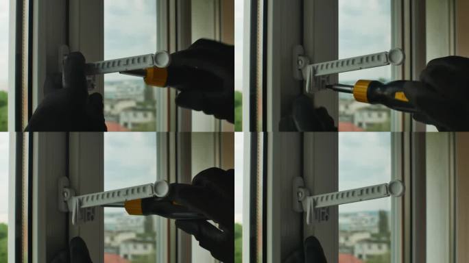 公用螺丝刀拧紧塑料开窗限位器固定螺钉带手套的手特写用螺丝刀拧紧窗限位器固定螺钉到塑料窗框上。回家修理