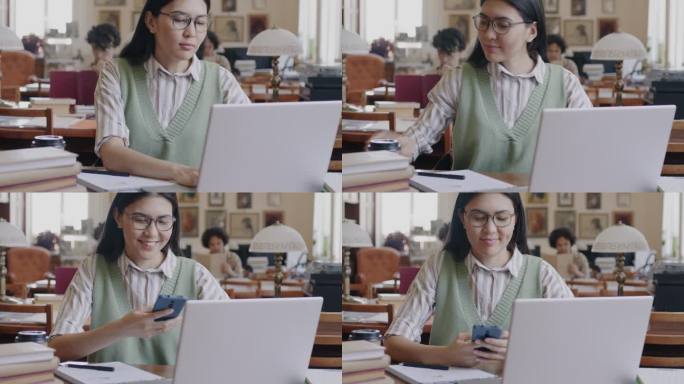 亚洲女生用笔记本电脑打字，用智能手机在大学图书馆学习