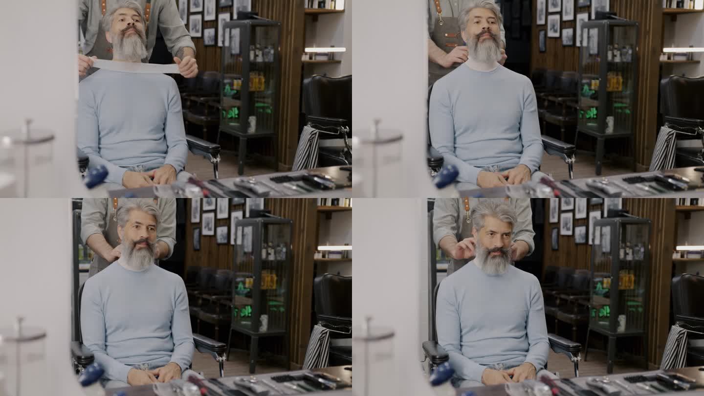 理发师在理发店里准备梳洗时，大胡子男子坐在椅子上