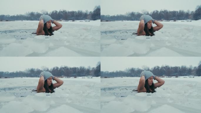 女人在冰天雪地里冬泳。在冷水中潜水