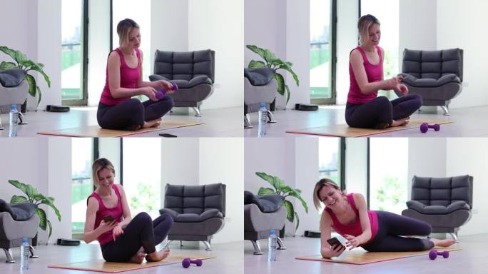 活跃的运动女性拿着哑铃锻炼肌肉和肱二头肌，而且还会因为发短信而分心