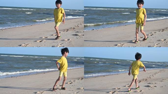 亚洲可爱的男孩在沙滩上玩沙子，慢动作的场景
