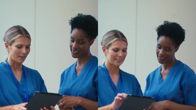 两个成熟的女医生在医院用数字平板电脑会面的垂直视频