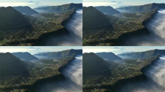 印度尼西亚东爪哇岛腾格里火山口的布罗莫山，云雾缭绕的日出景象，无人机在村庄上空移动