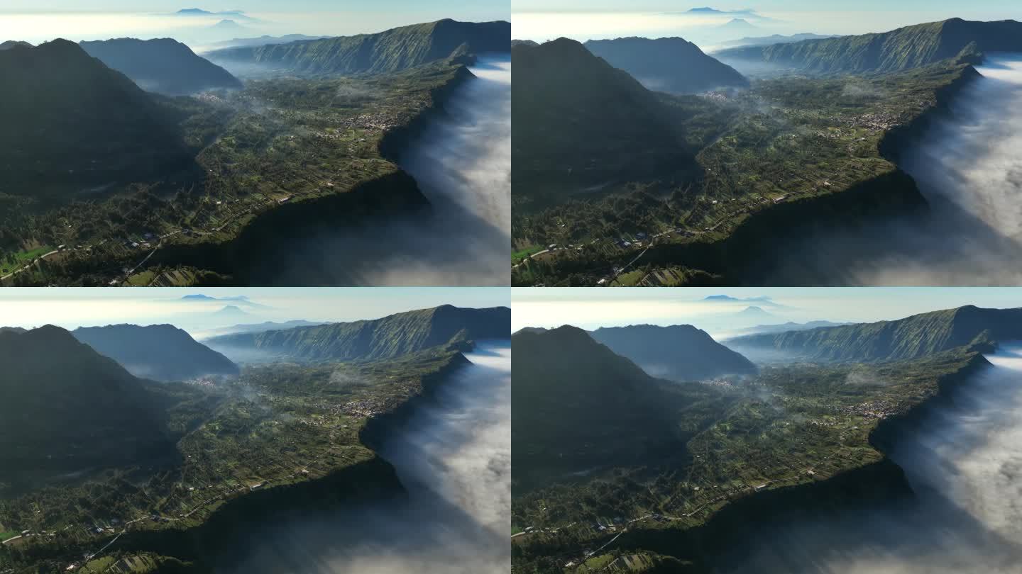 印度尼西亚东爪哇岛腾格里火山口的布罗莫山，云雾缭绕的日出景象，无人机在村庄上空移动