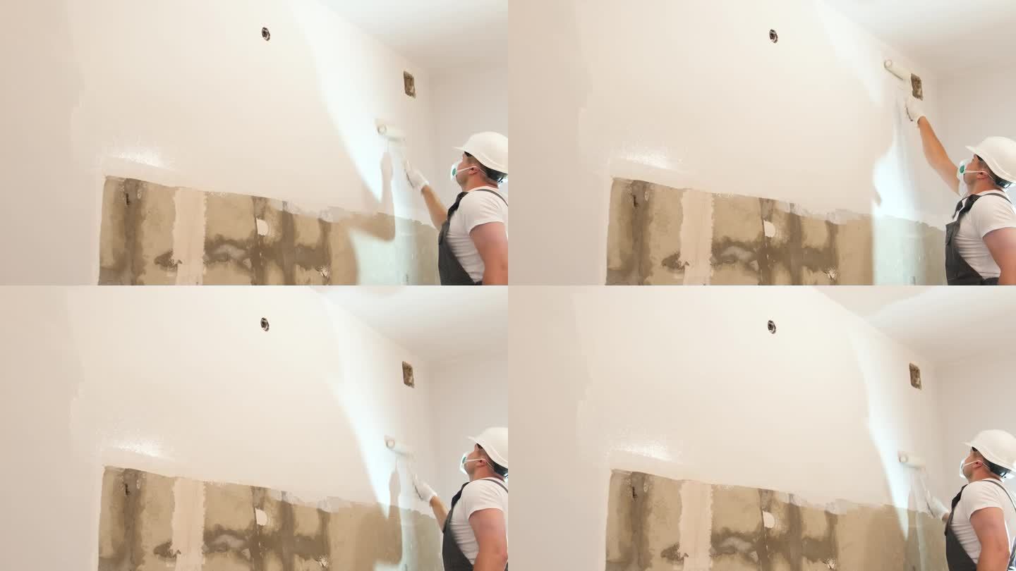 一个人把墙漆成白色。那个人正在修理房间。房子的内饰很现代。