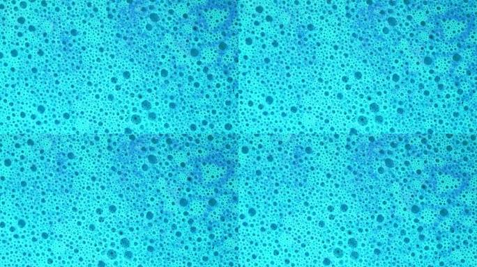 皂液微观结构。带有气泡的蓝色泡沫肥皂，旋转抽象背景，微距镜头，4k。