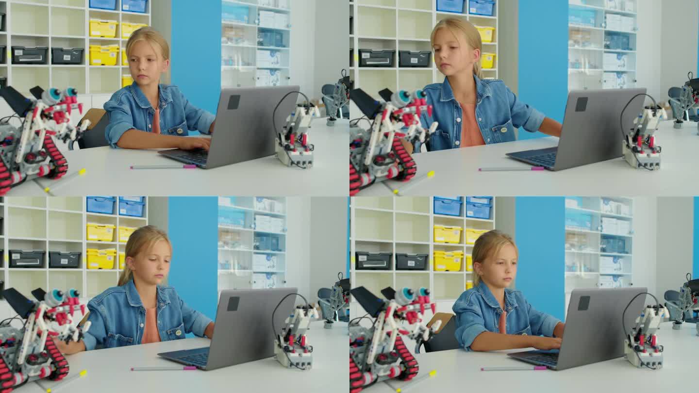年轻的白人女孩在业余爱好俱乐部为电动机器人编写程序