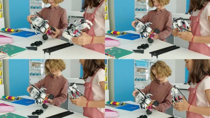 学龄前男孩和女孩在爱好俱乐部建造电动玩具机器人