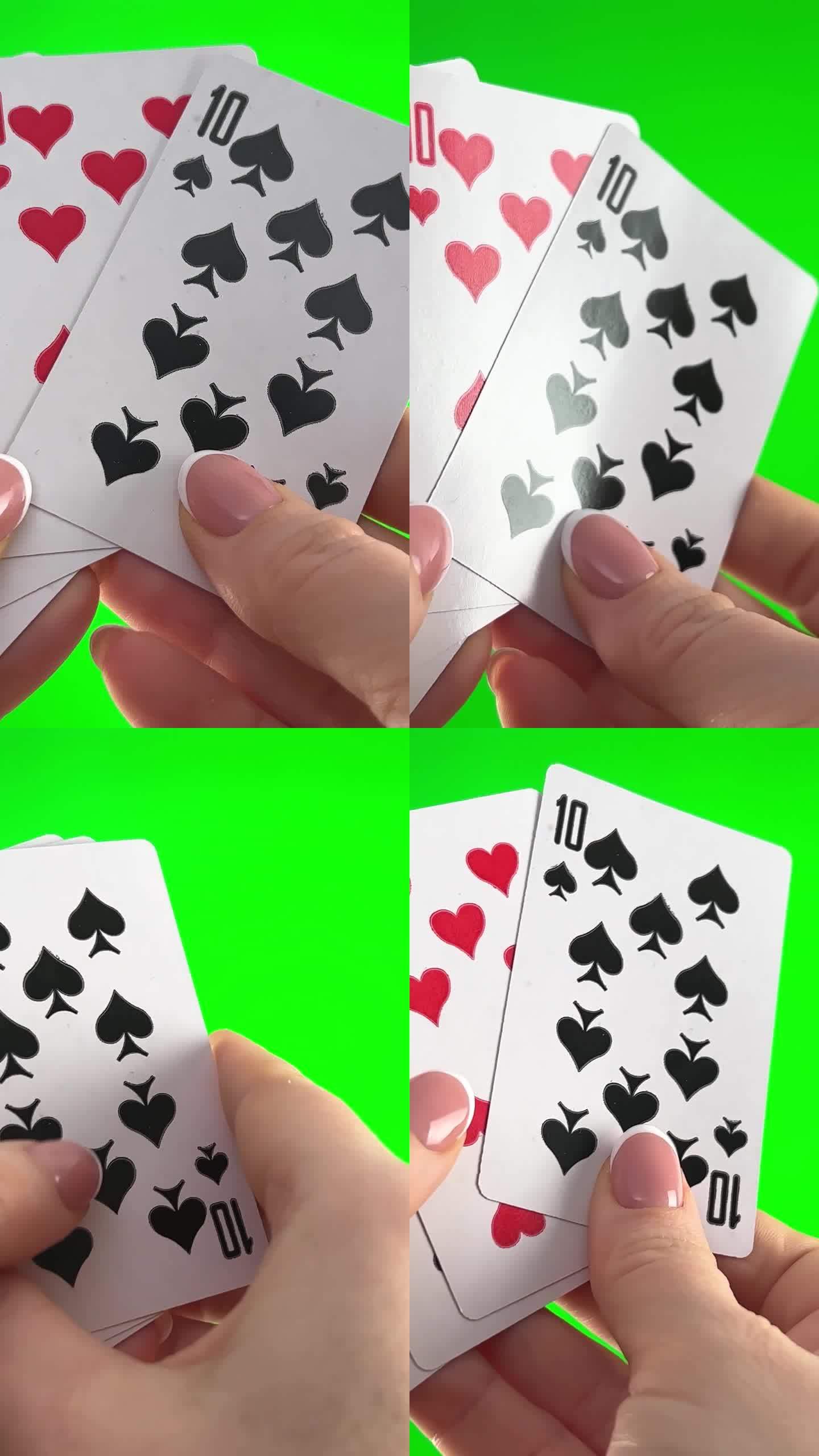 女性的手，法式美甲。女人整理卡片，检查折叠，像扇子一样展开同一套衣服剩下的四张卡片，手拿着四打卡片，