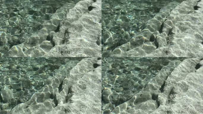 透明的流水，大圆石，石头，卵石在底部。