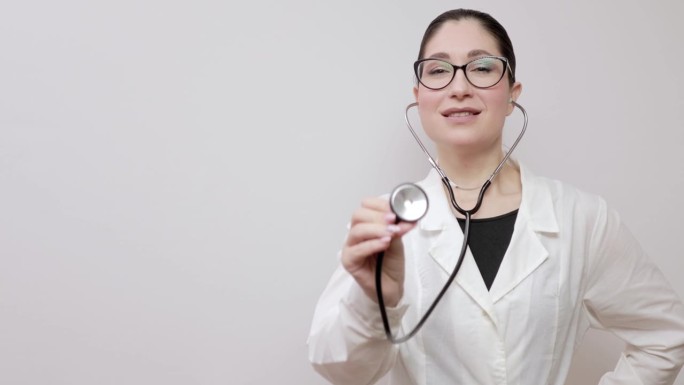 年轻的欧洲女性全科医生，戴着眼镜，穿着白色大褂，戴着听诊器。全科医生的特写肖像